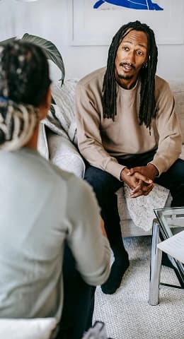 Man talking to a therapist, looking distressed